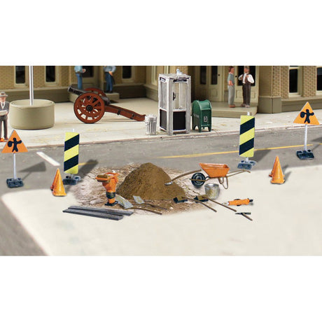 Road Crew Details - HO Scale - This set includes an assortment of Road Crew tools and supplies: warning signs, cones, a wheelbarrow, shovels, rakes, poles, a pile of ballast and a bucket
