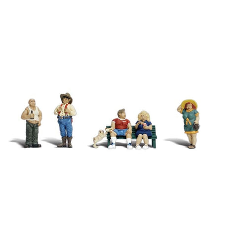 Full Figured Folks -  HO Scale - A man and a woman sit on a park bench, the woman holds her popcorn, while the man remains totally unaware of the pudgy pug dog trying to steal his hot dog
