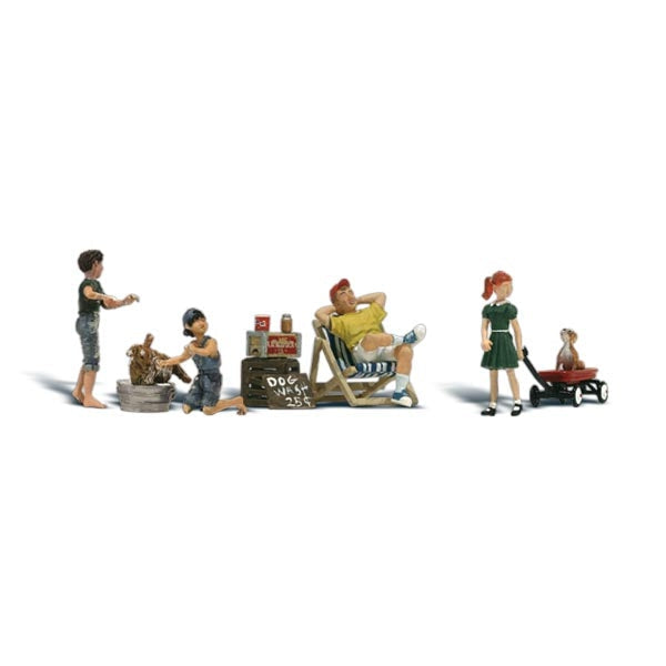 Dog Wash - HO Scale - A man relaxes in his chair, two kids wash dogs and a young woman pulls a young child in a wagon